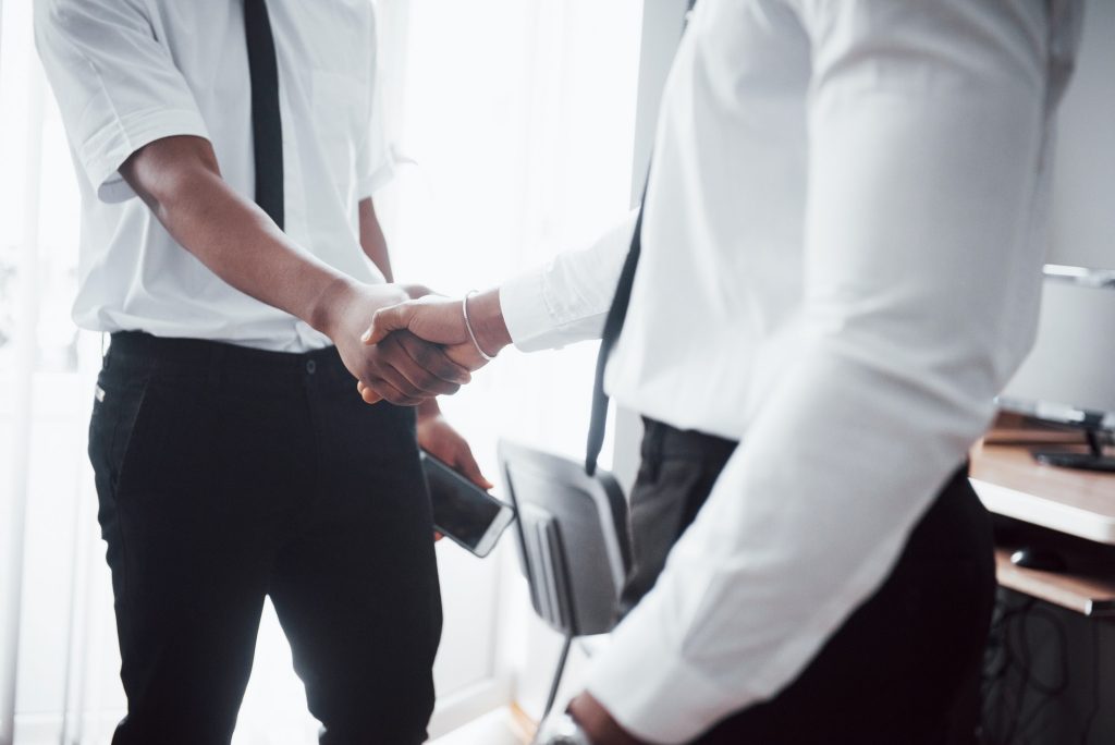 Business partnership concept. Photo of two businessman handshaking process. Successful deal after